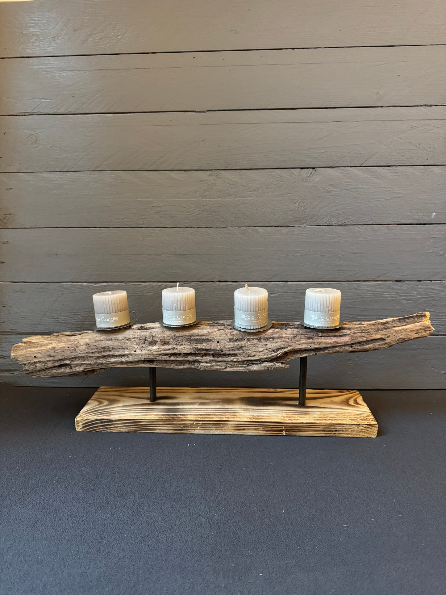 Detailaufnahme „Nordwind“ – echtes Ostsee-Treibholz auf geflammtem Holzfuß mit Metallhalterung.