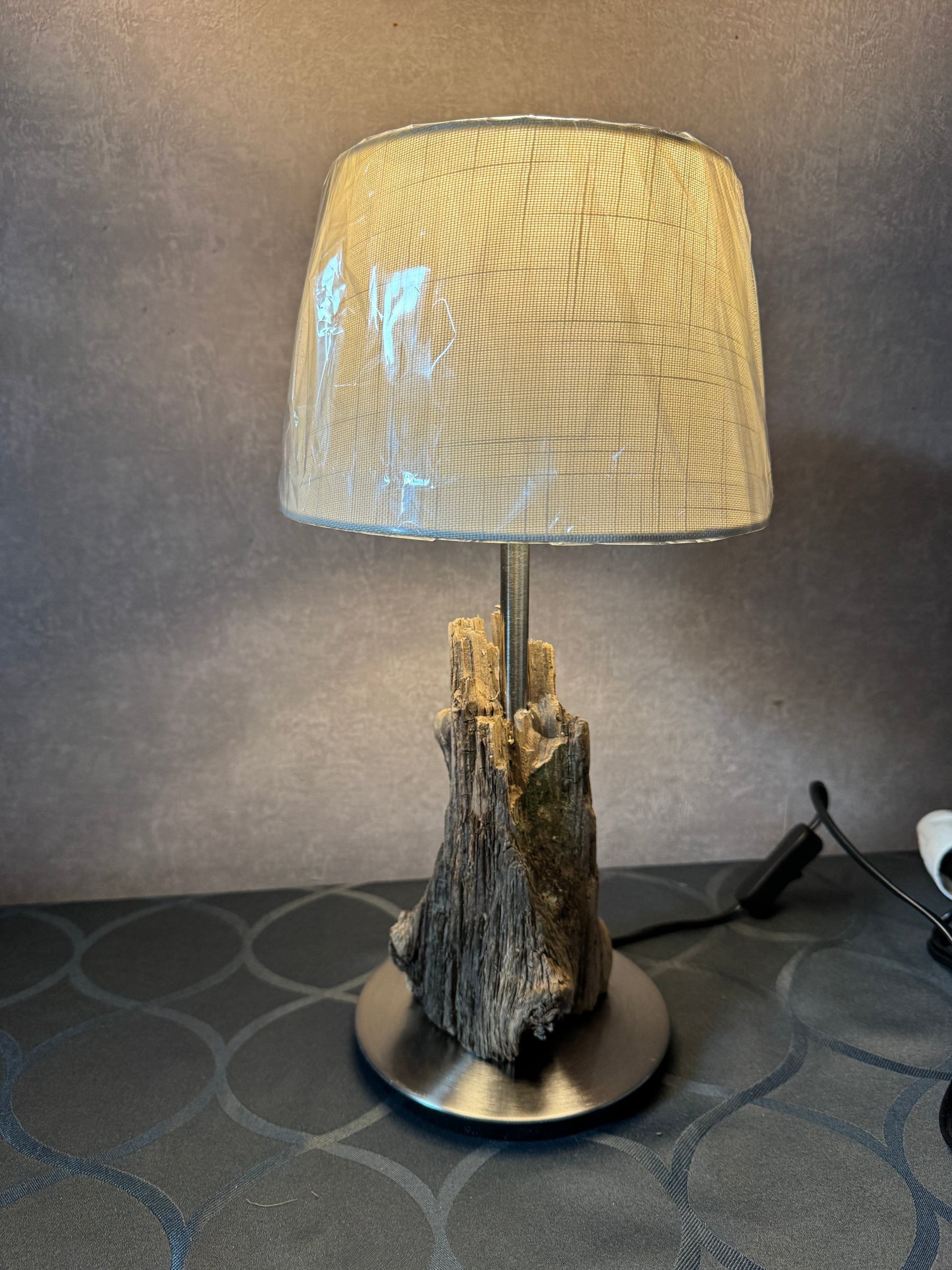 Lampe mit naturbelassenem Treibholz auf schlichtem Fuß